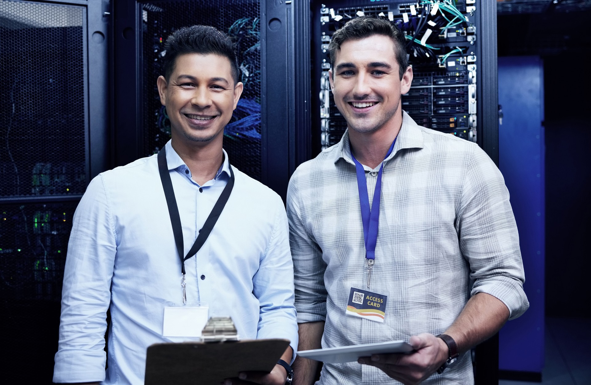 Shot of two young men working together in a server room